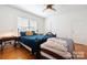 Bedroom with hardwood floors, large bed, and ceiling fan at 515 S Academy St, Lincolnton, NC 28092
