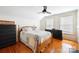 Bedroom with wood floors, ceiling fan, and wood bed frame at 515 S Academy St, Lincolnton, NC 28092