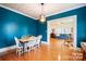 Charming dining room with teal walls and white chairs at 515 S Academy St, Lincolnton, NC 28092