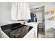 Laundry room includes washer, dryer, and storage shelving at 515 S Academy St, Lincolnton, NC 28092