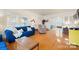 Living room with hardwood floors, blue couch, and views to other rooms at 515 S Academy St, Lincolnton, NC 28092