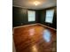 This bedroom features hardwood floors, painted walls, and windows for natural light at 906 N Flint St, Lincolnton, NC 28092