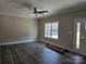 Spacious living room featuring dark laminate flooring, ample natural light, and a contemporary ceiling fan at 2054 Cane Mill Rd, Lancaster, SC 29720