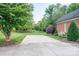 Brick home featuring mature trees and a pristine lawn on a sunny day at 2840 Wheat Field Ct, Lincolnton, NC 28092