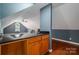 Wet bar featuring black countertops, wood cabinets, with additional living space at 2840 Wheat Field Ct, Lincolnton, NC 28092