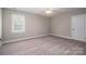 Neutral bedroom featuring neutral carpet, and large window with plantation shutters at 2840 Wheat Field Ct, Lincolnton, NC 28092