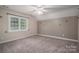 Bedroom featuring neutral carpet, and large window with plantation shutters at 2840 Wheat Field Ct, Lincolnton, NC 28092