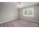 Neutral bedroom featuring large window, ceiling fan, and neutral carpet at 2840 Wheat Field Ct, Lincolnton, NC 28092