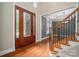 Welcoming foyer with a decorative glass front door, hardwood flooring, and view of the staircase and dining room at 2840 Wheat Field Ct, Lincolnton, NC 28092