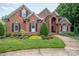 Charming brick home featuring manicured landscaping, arched windows, and a welcoming front entrance at 2840 Wheat Field Ct, Lincolnton, NC 28092