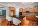 Kitchen featuring dark countertops, wood cabinets, stainless steel appliances, and a central island with seating at 2840 Wheat Field Ct, Lincolnton, NC 28092