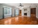 Spacious living room featuring hardwood floors, built-in bookshelves, a fireplace, and natural light from large windows at 2840 Wheat Field Ct, Lincolnton, NC 28092