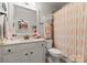 Clean bathroom with a vanity, toilet, shower, and peach-colored shower curtain at 308 Montrose Dr, Waxhaw, NC 28173