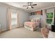 Bright bedroom with a comfortable bed, large windows, and soft pink accents at 308 Montrose Dr, Waxhaw, NC 28173