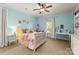 Light teal bedroom featuring a bed, desk, and plenty of natural light at 308 Montrose Dr, Waxhaw, NC 28173