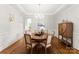 Elegant dining room features hardwood floors, a round table, and a beautiful chandelier at 308 Montrose Dr, Waxhaw, NC 28173