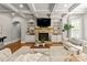 Spacious living room with a stone fireplace, built-in shelves, and coffered ceiling at 308 Montrose Dr, Waxhaw, NC 28173