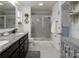 Bathroom with a tiled walk-in shower, granite countertops, and updated fixtures at 7456 Hartsfield Dr, Lancaster, SC 29720