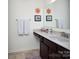 Well-lit bathroom featuring a granite vanity top, decorative towels, and matching accessories at 7456 Hartsfield Dr, Lancaster, SC 29720