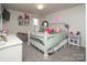 Charming bedroom featuring ample natural light, a gray accent wall, and carpeted floor at 7456 Hartsfield Dr, Lancaster, SC 29720