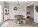 Bright dining area with a white hutch, unique light fixture, and adjacent office space at 7456 Hartsfield Dr, Lancaster, SC 29720