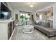 Cozy living room with a modern sofa, decorative plants, and ample natural light at 7456 Hartsfield Dr, Lancaster, SC 29720