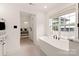 Sunlit bathroom featuring a soaking tub and a modern walk-in shower; neutral palette at 1046 Sutton Spring Rd, York, SC 29745