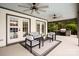 Stylish covered patio featuring comfortable seating, ceiling fans, and outdoor kitchen area at 1046 Sutton Spring Rd, York, SC 29745