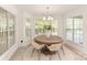 Cozy dining area with large windows offering abundant natural light and a modern light fixture at 1046 Sutton Spring Rd, York, SC 29745