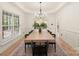 Elegant dining room featuring white walls, decorative trim, a modern chandelier and large table for entertaining at 1046 Sutton Spring Rd, York, SC 29745