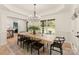 Dining room showcasing decorative trim, hardwood floors, modern chandelier, and large windows overlooking the yard at 1046 Sutton Spring Rd, York, SC 29745