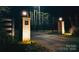 Nighttime shot of lighted brick entrance columns with address plaque, and automatic driveway gate beyond at 1046 Sutton Spring Rd, York, SC 29745