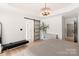 Bright main bedroom with modern lighting fixture, barn door, and neutral decor at 1046 Sutton Spring Rd, York, SC 29745