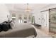 Airy main bedroom with a tray ceiling, a sliding barn door, and backyard access at 1046 Sutton Spring Rd, York, SC 29745