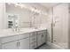 This bathroom features double sinks, quartz countertops and a glass enclosed shower at 429 Nathaniel Way # Brx0032, Charlotte, NC 28213