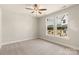 Bedroom with carpet floors, a ceiling fan, and large windows offering views of the surrounding area at 429 Nathaniel Way # Brx0032, Charlotte, NC 28213