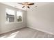 Bright bedroom with neutral carpet, ceiling fan, and natural light from two windows at 429 Nathaniel Way # Brx0032, Charlotte, NC 28213