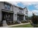 Attractive townhouses with gray siding, black trim, covered entrances, and green lawn in a well-kept neighborhood at 429 Nathaniel Way # Brx0032, Charlotte, NC 28213