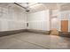 Unfinished garage with concrete flooring and a door leading to the home's interior at 429 Nathaniel Way # Brx0032, Charlotte, NC 28213