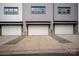 Townhouse garages with white doors and grey exterior; each unit has a single-car garage at 429 Nathaniel Way # Brx0032, Charlotte, NC 28213