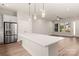 Bright open-concept kitchen flows to the living area, featuring a large island and stainless steel refrigerator at 429 Nathaniel Way # Brx0032, Charlotte, NC 28213