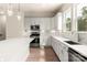 Modern kitchen with white cabinetry, stainless steel appliances, a center island, and wood flooring at 429 Nathaniel Way # Brx0032, Charlotte, NC 28213