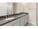 Modern bathroom featuring double sink vanity, gray quartz countertops, and a large mirror at 433 Nathaniel Way # Brx0033, Charlotte, NC 28213