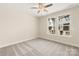 Comfortable bedroom with cozy carpet, natural light from a double window, and a ceiling fan at 433 Nathaniel Way # Brx0033, Charlotte, NC 28213