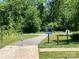 Scenic view of the Toby Creek Greenway entrance, lined with lush trees and clear signage, perfect for outdoor recreation and nature walks at 433 Nathaniel Way # Brx0033, Charlotte, NC 28213