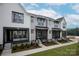 Attractive townhouses with varying gray siding and black accents, landscaped yards, and welcoming front porches, all under a bright sky at 433 Nathaniel Way # Brx0033, Charlotte, NC 28213