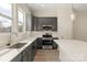 Well-lit kitchen features grey cabinets, stainless steel appliances, quartz counters and sink under window at 433 Nathaniel Way # Brx0033, Charlotte, NC 28213