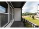 A balcony offers views of the neighborhood with tidy lawn and young trees at 437 Nathaniel Way # Brx0034, Charlotte, NC 28213