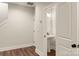 Bright, neutral bathroom featuring pedestal sink, white door, and tile flooring at 437 Nathaniel Way # Brx0034, Charlotte, NC 28213