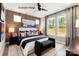 Serene main bedroom with paneled accent wall, light neutral carpet, and large windows showcasing a verdant view at 437 Nathaniel Way # Brx0034, Charlotte, NC 28213